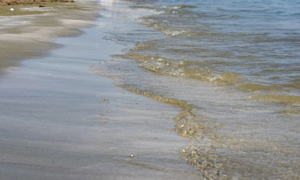 Close-up da orla marítima e areia com ondas de água claras  . — Fotografia de Stock