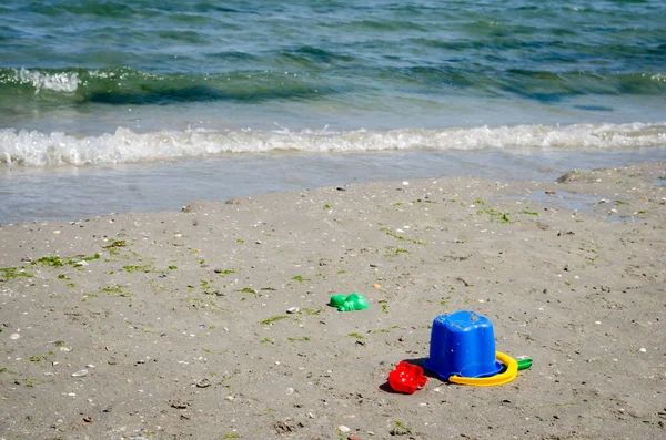 Vista de perto de diferentes brinquedos para crianças na praia de areia  . — Fotografia de Stock