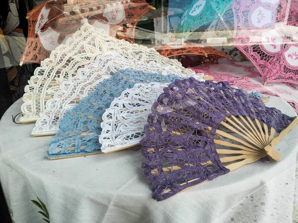 Multiple  handmade and  embroidered fan exposed for sale in a local store