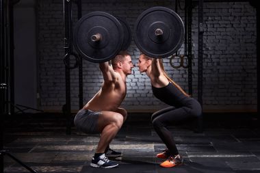 CrossFit kaldırma çubuğu tarafından kadın ve erkekte grup egzersiz duvara karşı.