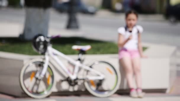 Carino bambina mangiare gelato nel parco della città in sole giorno d'estate . — Video Stock