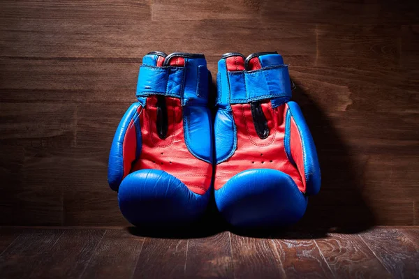 Boxing background with two gloves on the brown plank background. — Stock Photo, Image