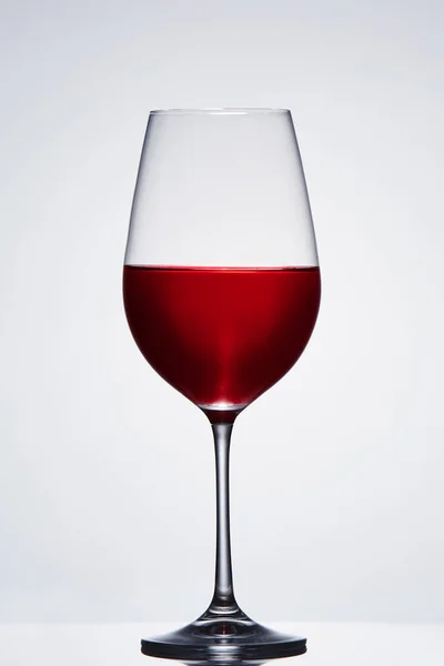 밝은 배경에 대 한 레드 와인의 깨지기 쉬운 우아한 와인 글라스. — 스톡 사진