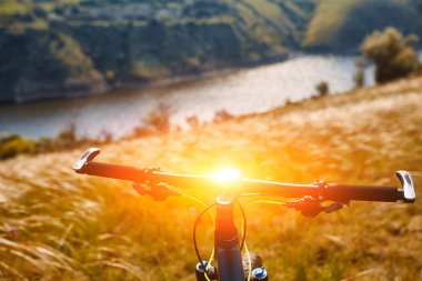 Bisikletle tepeden aşağıya doğru hızla inen dağ bisikleti. Motorcuların gözlerinden bak.