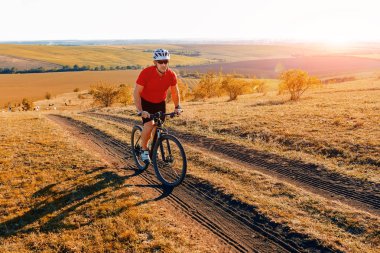 Güzel sonbahar üzerinde Bisiklete binmek sırt çantası ile seyahat