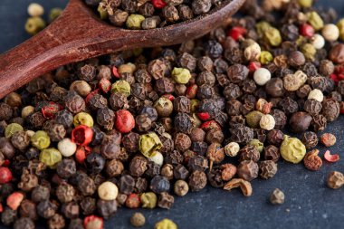 bir taş zemin üzerine bir kaşık karabiber bezelye