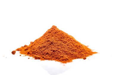 A pile of ground powder paprika isolated on white background, close-up, shallow depth of field clipart