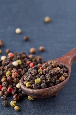 Koyu arka plan üzerine sığ derinlik-in tarla, ön odak izole yenibahar tohumların tam bir tahta kaşıkla Üstten Görünüm