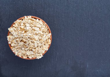 Köşede siyah bir taş zemin üzerine yerleştirilmiş sarı yulaf piramit