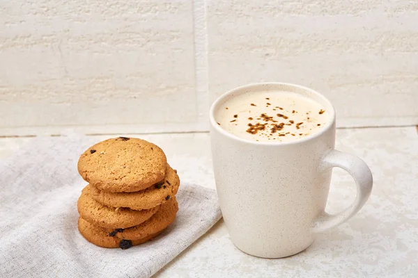 Cup of coffee and biscuit isolated on the white background, close-up, shallow depth of field.