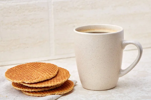 Cup of coffee and biscuit isolated on the white background, close-up, shallow depth of field