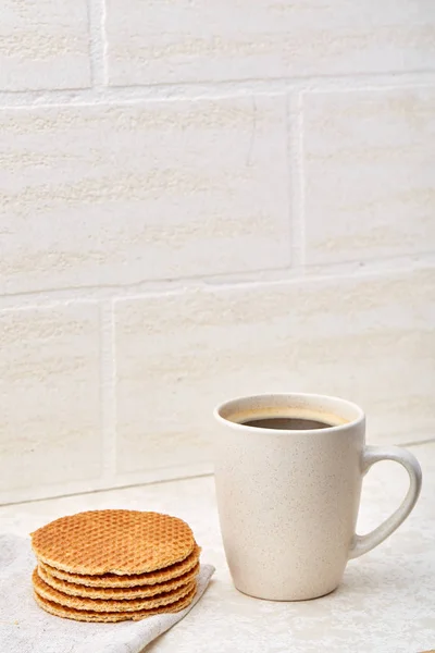 Cup of coffee and biscuit isolated on the white background, close-up, shallow depth of field