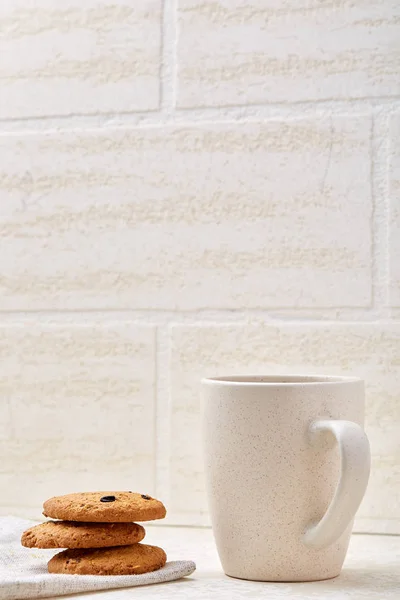 Cup of coffee and biscuit isolated on the white background, close-up, shallow depth of field.