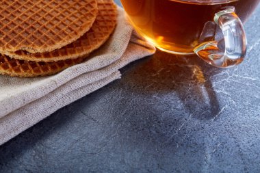 Siyah çay waffle koyu grimsi mermer zemin ile cam fincan. Kahvaltı arka plan
