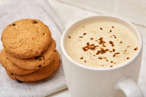 Primer plano taza blanca de café con galletas de chispas de chocolate sobre fondo blanco, vista superior —  Fotos de Stock