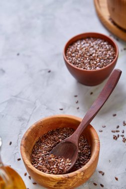 Ahşap kase ve rustik ahşap arka plan, üstten görünüm, sığ derinlik-in tarla kaşık keten tohumu