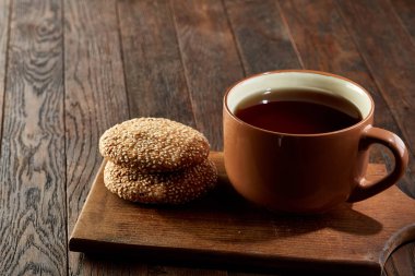 Antika arka plan, üstten görünüm üzerinde bir ahşap kesme tahtası üzerinde kurabiyeyle çay