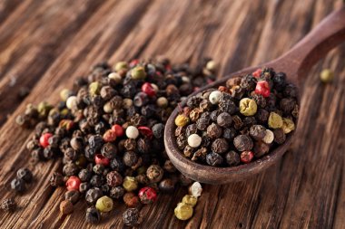 Siyah, kırmızı ve beyaz karabiber ahşap arka plan üzerine sığ derinlik-in tarla izole üzerinde Üstten Görünüm.