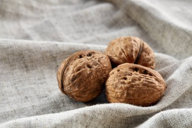Birlikte hafif gri Kumaş Pamuk masa örtüsü seçici odak kazıklı ceviz sert kabukları yığını