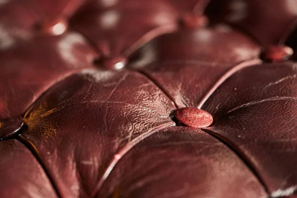 Dark brown leather background, close-up, shallow depth of field