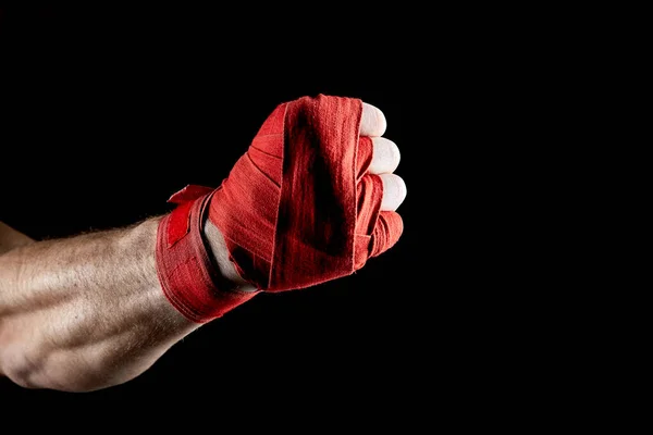 Červené boxerky obvaz na ruce izolované na tmavé rozmazané pozadí, detail. — Stock fotografie