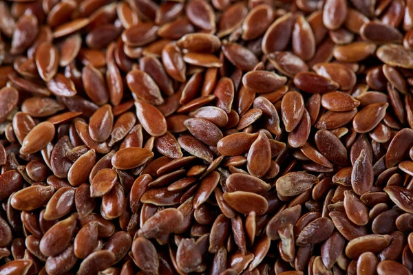 Top view close-up picture of separate flax seed on light textured background, macro, selective focus. — Stock Photo, Image