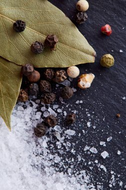 Bay defne yaprak biber ve tuz izole koyu arka plan, üstten görünüm, yakın çekim, seçici odak bileşimi