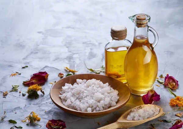 Composition of spa treatment on white background. Sea salt and flowers background, close up, top view, selective focus.