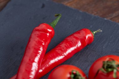 Taze üzüm domates, biber ve tuz ahşap zemin, seçici odak üzerine tahta kaşık ile vejetaryen natürmort