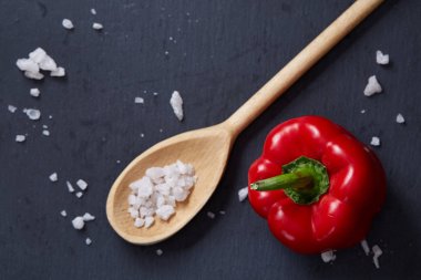 Taze üzüm domates, biber ve tuz ahşap zemin, seçici odak üzerine tahta kaşık ile vejetaryen natürmort