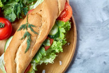 Marul, domates ve peynir ile taze sandviç ahşap beyaz dokulu arka plan üzerinde seçici odak tabakta