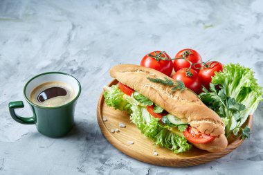 Marul, domates, peynir ahşap plaka üzerinde kahve beyaz arka planda, seçici odak ile taze sandviç