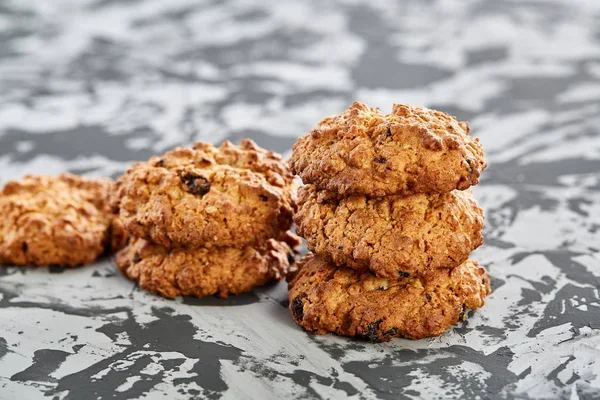 Sweet cookies arranged in pattern on light textured background, close-up, shallow depth of field, selective focus.