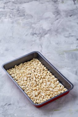 Tepsi üzerinde beyaz ekmek üzerinde soyulmuş fıstık dokulu arka plan, seçici odak, sığ derinlik-in tarla.