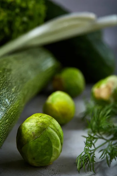 Fresh vegetables still life over white textured background, close-up, flat lay, shallow depth of field