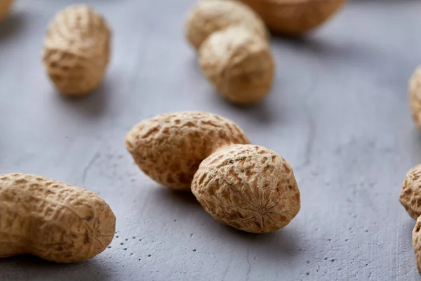 Seamless pattern shelled peanuts isolated on white background, top view, close-up, selective focus