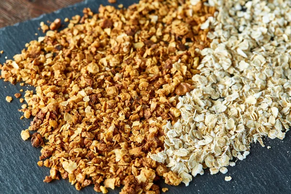 Healthy mix of granola and oatmeal on dark background, top view, close-up, selective focus — Stock Photo, Image