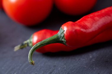 Taze üzüm domates, biber ve tuz ahşap zemin, seçici odak üzerine tahta kaşık ile vejetaryen natürmort