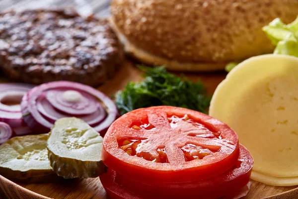 Tasty hamburger ingredients are laid out separately from above, beautifully harmoniously, close-up, top view