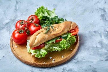 Marul, domates ve peynir ile taze sandviç ahşap beyaz dokulu arka plan üzerinde seçici odak tabakta