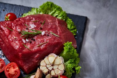 Sebze ile kayrak yönetim kurulu ve baharat, seçici odak, yakın çekim çiğ biftek bileşimi.