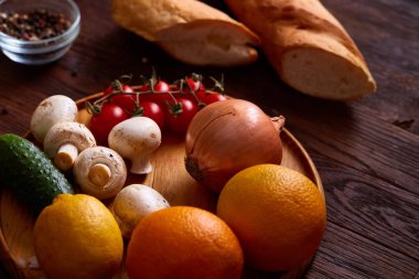 Kiraz domates, mantar ve ahşap arka plan üzerinde kırmızı soğan vitamini meyve ve sebze toplama.