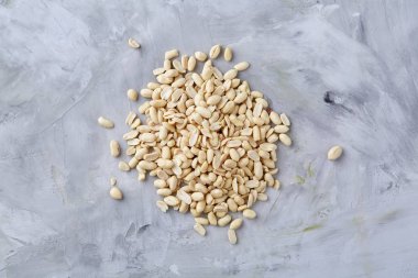 Yığın üzerinde izole peelled fıstık beyaz dokulu arka plan, arka plan, üstten görünüm, yakın çekim, seçici odak