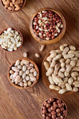 Bir kompozisyon farklı rustik arka plan, yakın çekim, sığ derinlik-in tarla ahşap bir kase içinde fındık çeşitleri