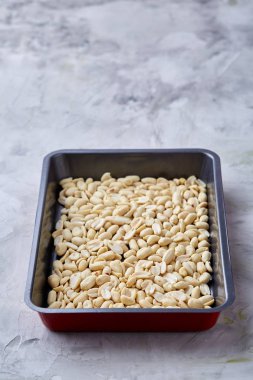 Tepsi üzerinde beyaz ekmek üzerinde soyulmuş fıstık dokulu arka plan, seçici odak, sığ derinlik-in tarla.