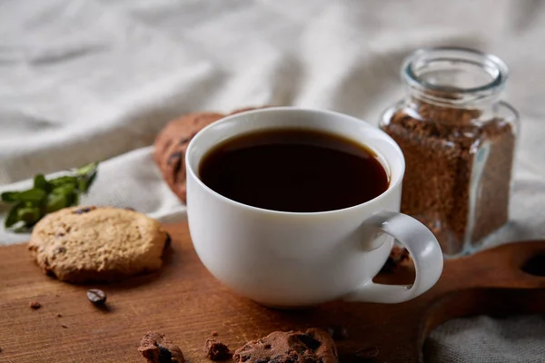 Breakfast background with mug of fresh coffee, homemade oatmeal cookies, grind coffee