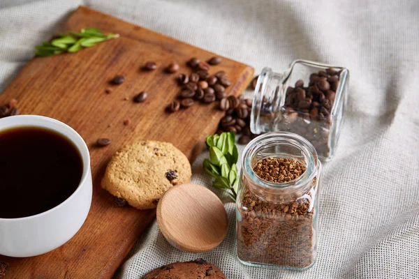 Breakfast background with mug of fresh coffee, homemade oatmeal cookies, grind coffee