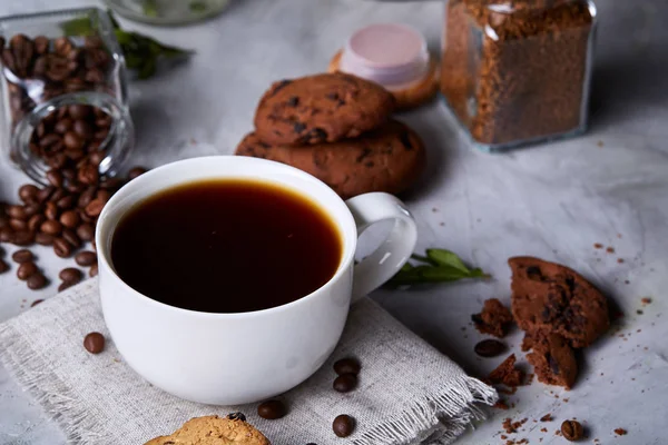 Breakfast background with mug of fresh coffee, homemade oatmeal cookies, grind coffee
