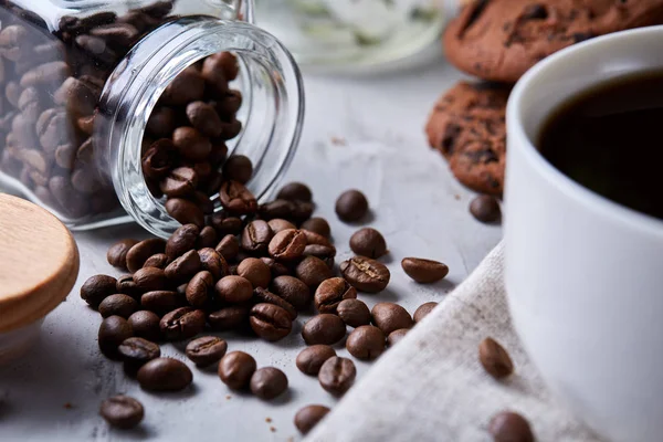 Breakfast background with mug of fresh coffee, homemade oatmeal cookies, grind coffee