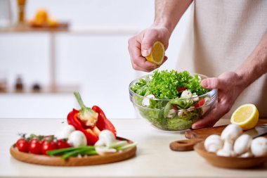 Adam seçici odak sağlıklı sebze salatası, yakın çekim, yapım mutfak yemek.